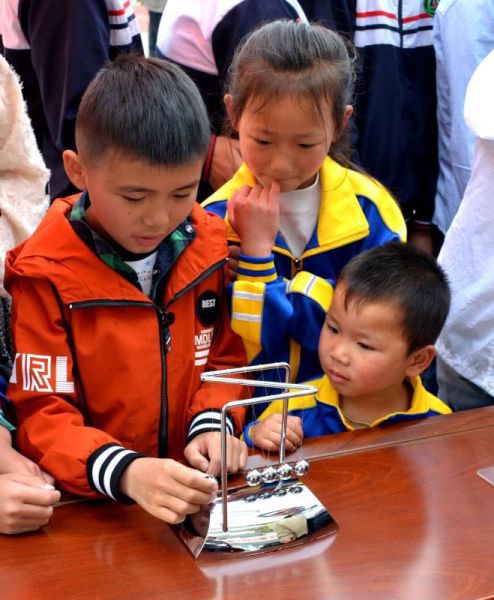 科普活动吸引众多学生观看，其中有不少是姐姐带着弟弟来“看热闹”。(杨凡/摄)